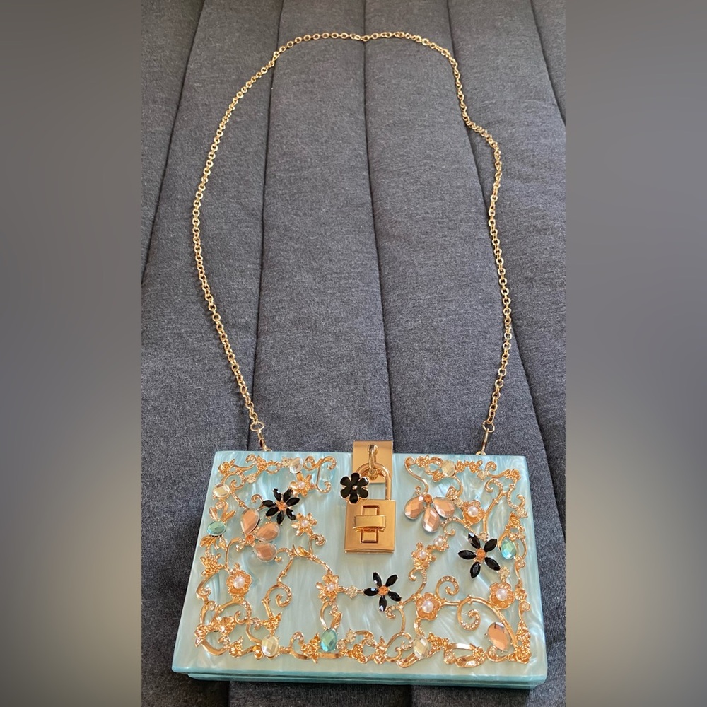 Acrylic clutch w rhinestone/crystal accents.